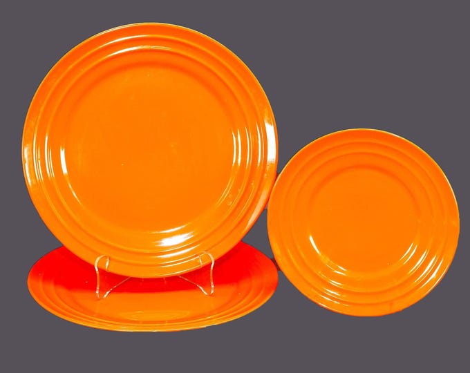 Three Rachael Ray Double Ridge Tangerine stoneware plates. Two large dinner, one salad plate.