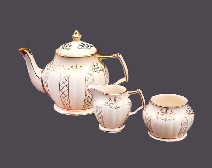 Sadler 3423 four-cup teapot, creamer and open sugar bowl set made in England. Flaw (see below).