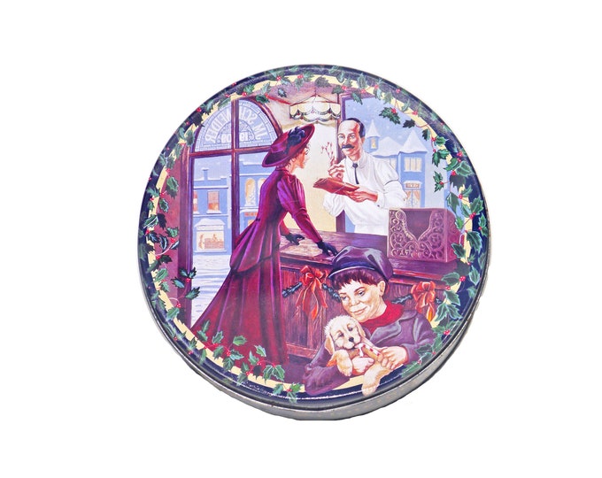 Schneider & Sons limited edition round tin with lid. Christmas image of a woman in period dress in the butcher shop.