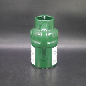 May include: A green ceramic pitcher shaped like a Tanqueray gin bottle. The pitcher has a handle and a label that reads "Tanqueray London Dry Gin."