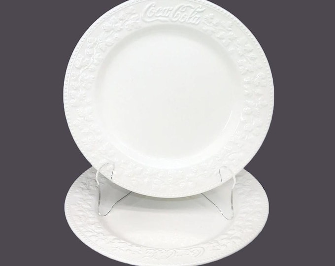 Pair of Coca-Cola Chef's favorite all-white dinner plates made in Italy by Quadrifoglio. Embossed Coca-Cola logo and leaves.