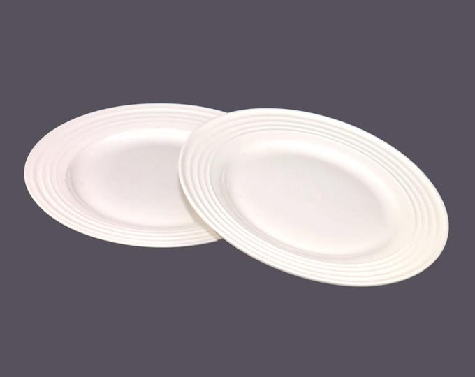 Pair of Paderno chef's favorite all-white salad plates with ribbed rims.