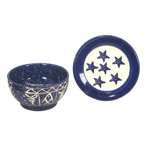 May include: A blue ceramic bowl with a white design and a matching blue ceramic plate with a white centre and blue stars.