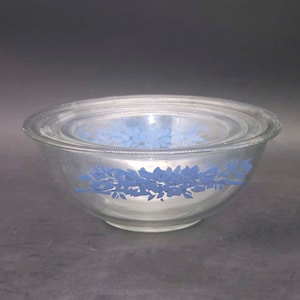 Three Pyrex PYR39 blue-and-white glass mixing bowls made in the USA. Etched-glass blue flowers and ribbons.