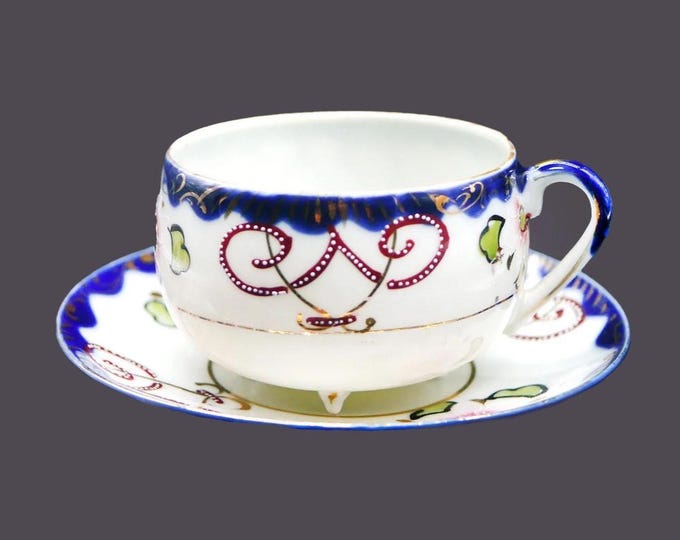 Art-deco era hand-painted Nippon moriage tea set (quad-footed cup with saucer). Cobalt, gold, maroon swirls, flowers.