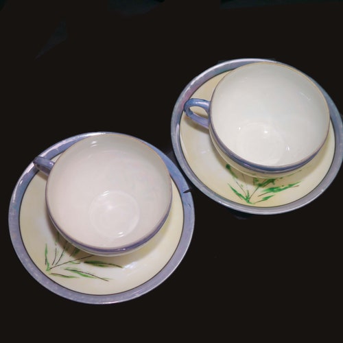 Nice pieces of hand-painted Nippon lilac lusterware. Orange florals, shops lilac luster. Five dessert plates, two tea sets.