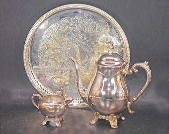 Mid-century F.B. Rogers silver-plate on copper tea service of teapot, creamer and round tray. Made in USA.