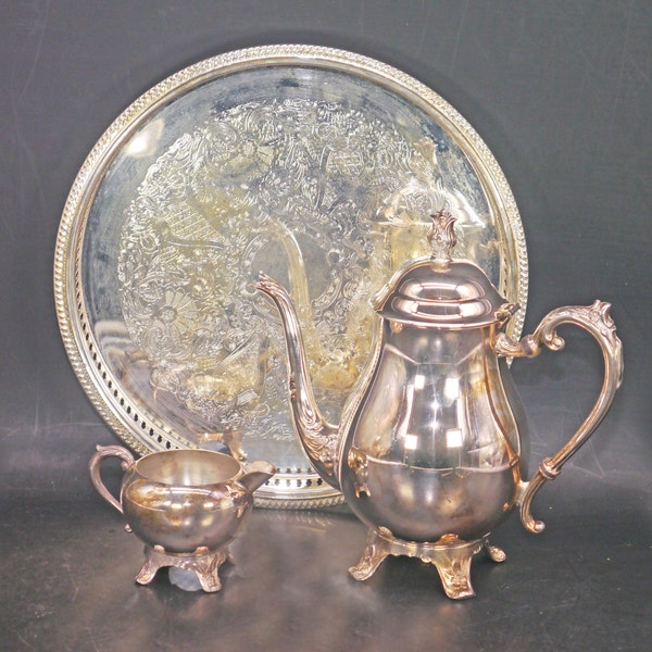 Mid-century F.B. Rogers silver-plate on copper tea service of teapot, creamer and round tray. Made in USA.