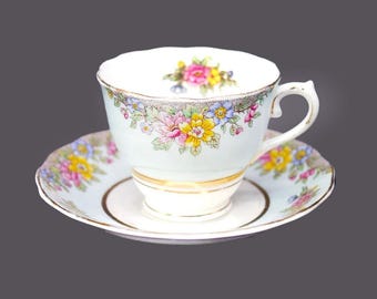 Colclough powder blue and florals bone china cup and saucer set made in England. Minor flaws (see below).