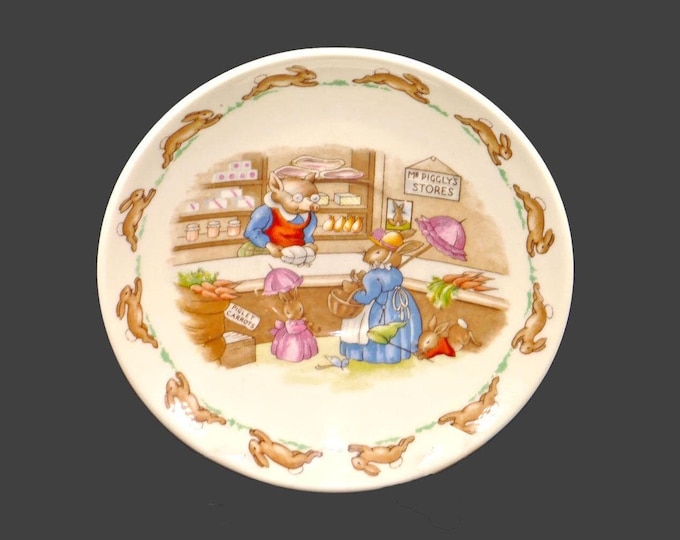 Royal Doulton Bunnykins orphaned saucer only made in England. The bunnies shopping at Mr. Piggly's store.