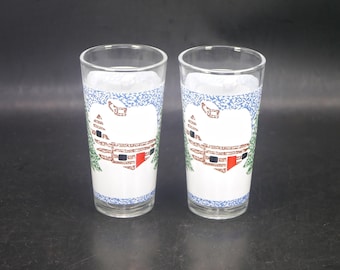 Pair of KIG Christmas Winter Scene Log Cabin in the Snow etched tumbler glasses. Christmas glassware made in Indonesia.