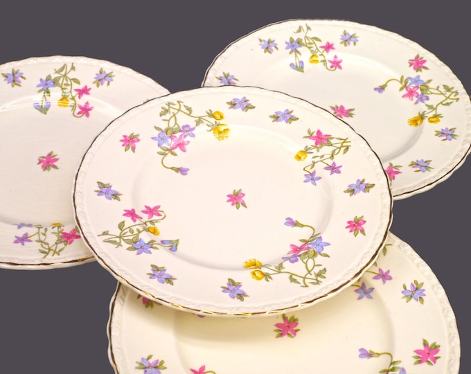 Four Myott Trouville bread plates made in England. Scalloped, gold edge. Flaw (see below).