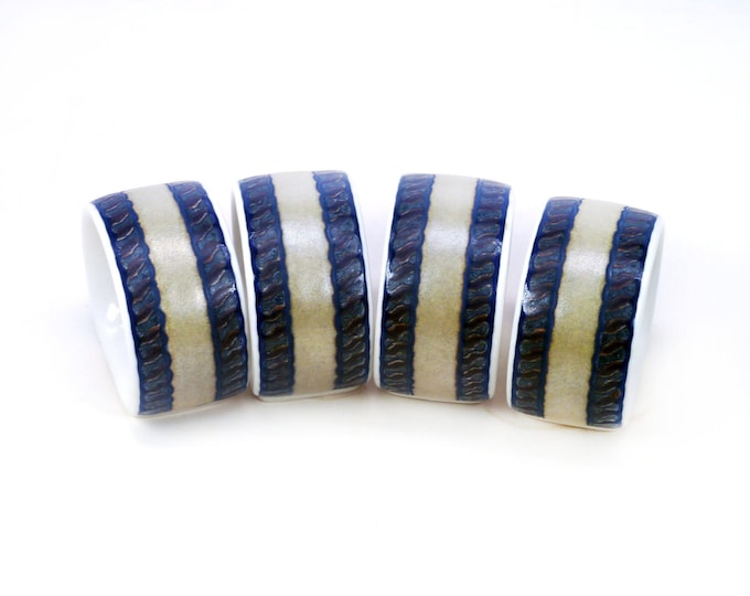 Four Mikasa Intaglio Arabella CAC01 napkin rings.