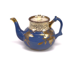 Art-deco era Sudlow 4094 four-cup teapot. Gold squiggles and florals on blue made in England.
