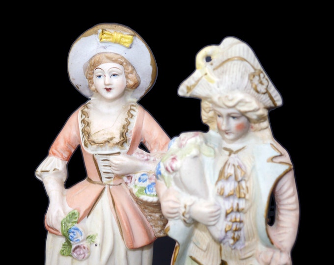 Pair of mid-century porcelain bisque figures. Man and woman in period dress. Made in Occupied Japan.