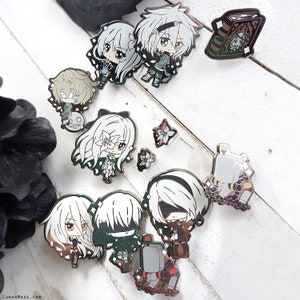 May include: A set of 10 enamel pins featuring various characters and designs. The pins are silver with black and white details. Some of the characters include a girl with long white hair, a girl with long black hair, and a robot. The pins are perfect for adding a touch of whimsy to your backpack, jacket, or bag.