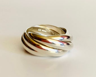 May include: A silver ring with a twisted, rope-like design.