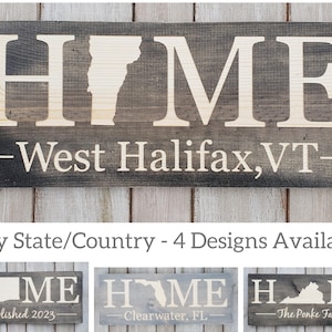 A 9x24" wood sign, design is engraved within the wood, top line says HOME in all capitals with a chosen state/country replacing the O, the second line has 5 custom design options- 1. Sweet Home 2.