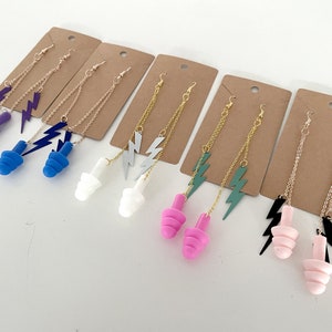 May include: Six pairs of earrings with different coloured silicone earplugs and gold chains with lightning bolt charms.