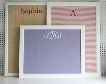 35x25 white plastic frame with an embroidered name or initial