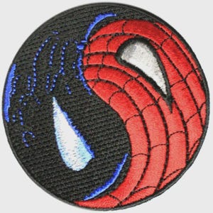 May include: Embroidered patch featuring a split design of Spider-Man's mask. One half is red with a web pattern, the other is black with blue accents. The patch is circular and has a textured appearance.