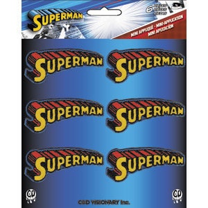 May include: Six Superman mini-appliques on a blue background. Each applique features the word "SUPERMAN" in yellow, outlined in red and black, with a blue shadow. The packaging includes the Superman logo and text.