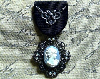 Gothic and Gunmetal Cameo: Vintage Gothic Resin Cameo Medal / Brooch with Iridescent Crystals with Neo-Classical Flourish on Black Ribbon