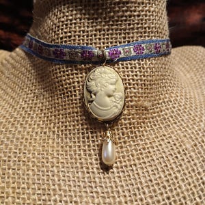 Dainty Victorian: Woman&#39;s Gibson Girl Profile in Glimmering Bronze Cameo Choker with Pearl Pendant on Antique Hand-Embroidered Ribbon