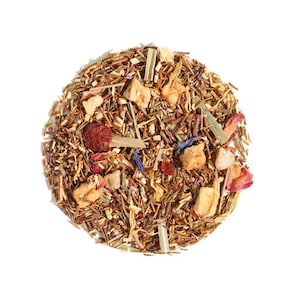 May include: A close-up of a blend of loose leaf tea with dried fruit pieces, including apple, berries, and flowers. The tea is a mix of brown, green, and yellow hues.