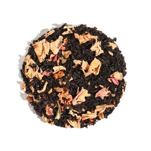 May include: A close-up of a blend of black tea leaves, dried rose petals, and other botanicals. The tea is a mix of black, pink, and orange hues.