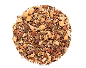 May include: A close-up of a blend of loose leaf tea with pieces of dried fruit, herbs, and spices. The tea blend is a mix of brown, orange, and green hues.
