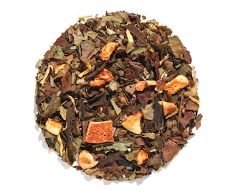May include: A close-up of a blend of white tea leaves, dried orange peel, and other botanicals. The tea is a light brown color with orange and white accents.