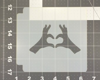 May include: A black silhouette of two hands forming a heart shape.
