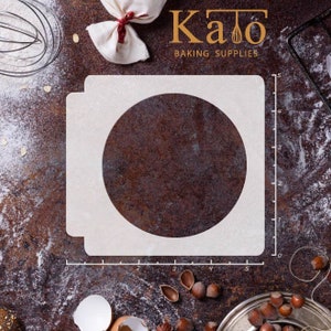 May include: White plastic baking stencil with a 5-inch diameter circle cutout. The stencil is on a brown surface with a ruler marked in inches.
