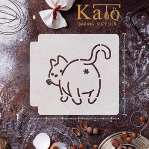 May include: A beige cat-shaped stencil for baking, with a playful design. The stencil features a cat's outline with a tail, ears, and a small asterisk detail. The text "Kato Baking Supplies" is visible in the image.