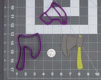 May include: Three cookie cutters, two purple axe-shaped cutters and one grey axe-shaped cutter with a yellow handle.