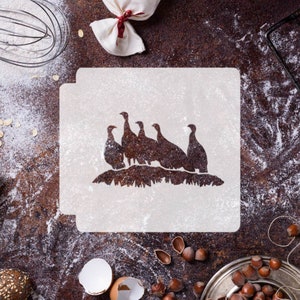 May include: A white stencil with a silhouette of a group of turkeys in a line. The stencil is on a brown surface with flour scattered around it.