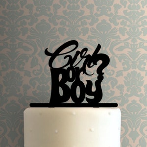 May include: Black cake topper with the text "Girl or Boy?" in a cursive font.