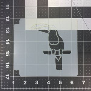 Puede incluir: Una plantilla en blanco y negro de un tucán posado en una rama. El tucán está mirando hacia la izquierda y tiene un pico grande.