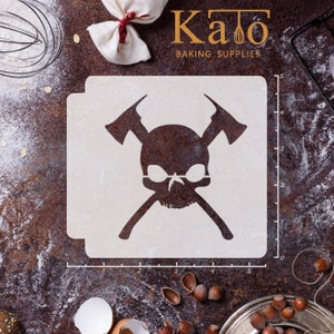 May include: White stencil with a skull and cross axes design. The stencil is on a brown surface with a ruler and other baking supplies.