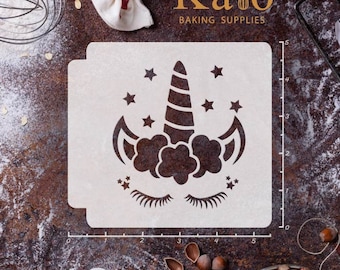May include: A white plastic stencil with a unicorn design. The unicorn has a horn, a mane, and eyelashes. There are stars around the unicorn. The stencil is 5 inches wide and 5 inches tall.