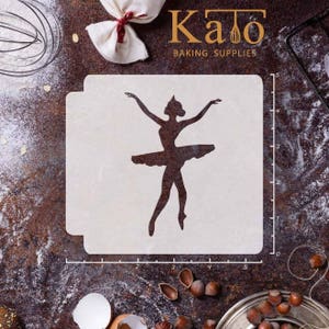 May include: A white stencil of a ballerina silhouette with a tutu, standing on a white surface with a ruler marked in inches.