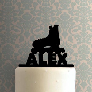May include: Black silhouette of a roller skate with the name Alex underneath. This is a cake topper.