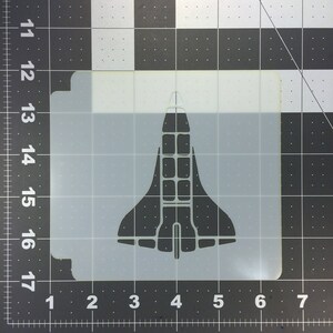 May include: A white stencil of a space shuttle, perfect for crafting projects.