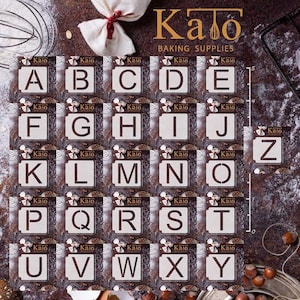 May include: A set of 26 alphabet cookie cutters, each letter is individually packaged in a white square with the word "Kalo" printed on it. The cutters are arranged in alphabetical order on a brown background with a ruler and various baking ingredients.