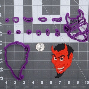 May include: A set of purple plastic cookie cutters in the shape of a devil's head, horns, eyes, and a mustache. A red plastic cookie cutter in the shape of a devil's head is also shown.