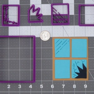 May include: A set of five purple plastic cookie cutters shaped like windows. The cutters are arranged on a gray gridded surface. The cutters include a square window, a window with a broken pane, a window with a diagonal pane, a window with a vertical pane, and a window with a diagonal pane and a broken pane.