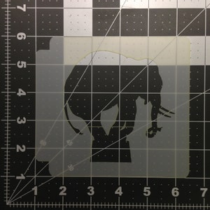 May include: A white plastic stencil of an elephant silhouette. The stencil is approximately 6 inches wide and 5 inches tall.