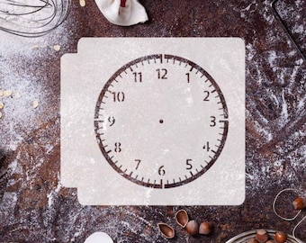 May include: A white baking stencil featuring a clock face design. The stencil is on a brown surface with flour and other baking ingredients.
