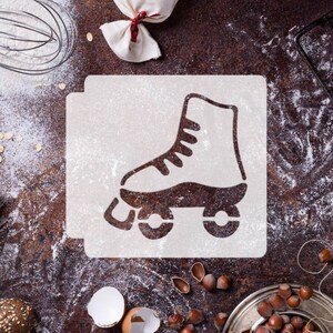 May include: A roller skate stencil on a square, dusted with flour. The stencil is brown, and the background is a textured, dark brown surface. Baking supplies and ingredients, including a whisk, flour, and nuts, surround the stencil.